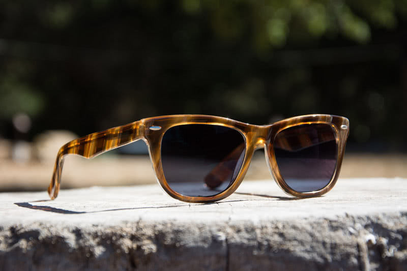 Tortoiseshell sunglasses with dark lenses.