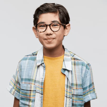 Young person wearing glasses, a yellow t-shirt, and a blue plaid button-up shirt.